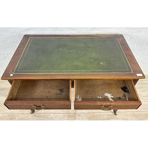 28 - An Edwardian inlaid mahogany and green leather two drawer writing table on tapering supports and bra... 