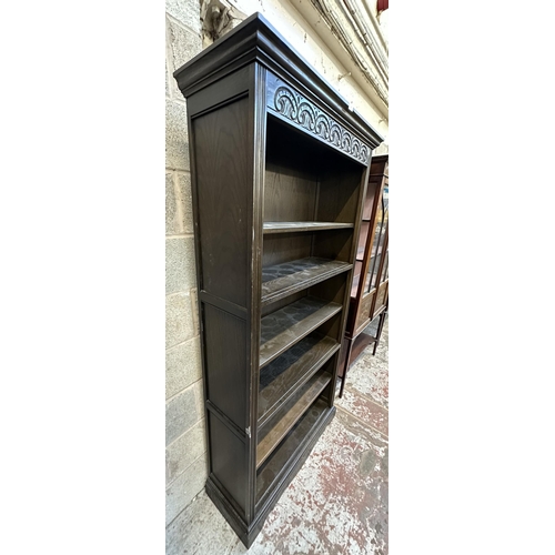 36 - An Old Charm carved oak six tier bookcase - approx. 188cm high x 99cm wide x 35cm deep