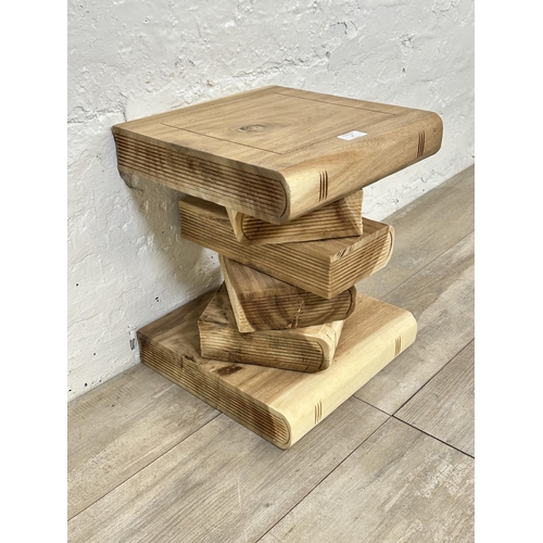 4 - A contemporary carved hardwood novelty book stack side table - approx. 41cm high x 33cm wide x 33cm ... 