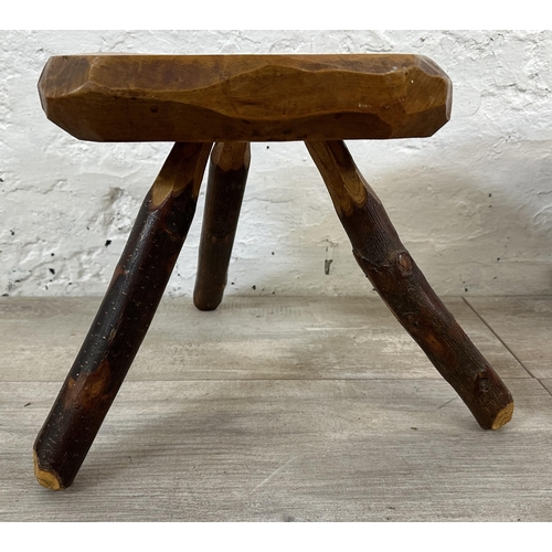 43 - A pair of Brutalist style rustic elm tripod stools - approx. 26cm high x 25cm wide x 21cm deep