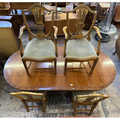 48 - A Georgian style yew wood twin pedestal extending dining table and six shield back chairs - approx. ... 