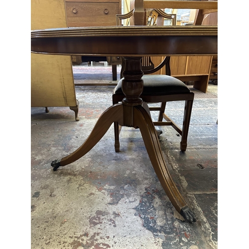 48 - A Georgian style yew wood twin pedestal extending dining table and six shield back chairs - approx. ... 