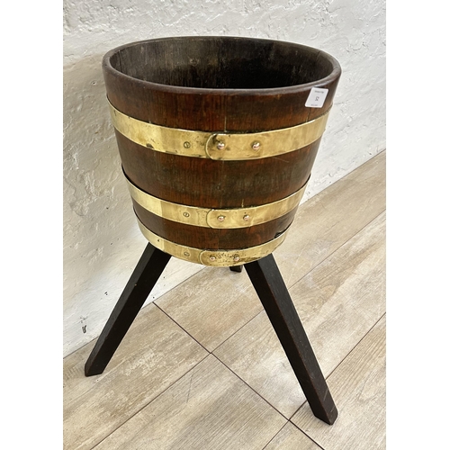 52 - An early 20th century coopered oak and brass planter on stand - approx. 59cm high x 31cm diameter