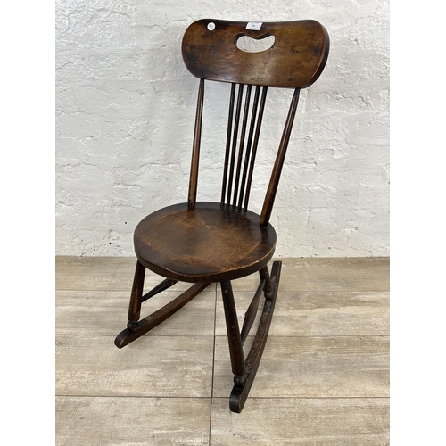 53 - An early 20th century beech spindle back penny seat rocking chair - approx. 85cm high x 36cm wide x ... 