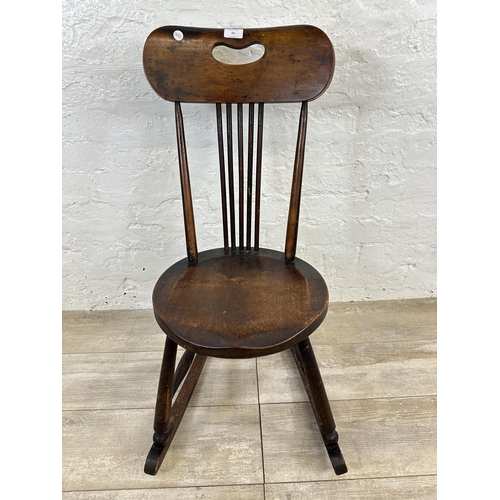 53 - An early 20th century beech spindle back penny seat rocking chair - approx. 85cm high x 36cm wide x ... 