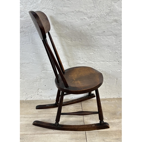 53 - An early 20th century beech spindle back penny seat rocking chair - approx. 85cm high x 36cm wide x ... 