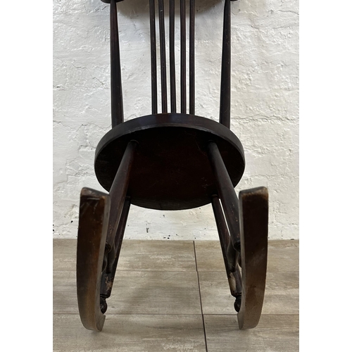 53 - An early 20th century beech spindle back penny seat rocking chair - approx. 85cm high x 36cm wide x ... 