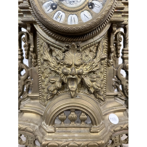 55 - A French Louis XV style brass mantel clock - approx. 60cm high