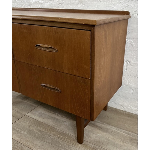 58 - A mid 20th century teak concave chest of drawers - approx. 72cm high x 108cm wide x 44cm deep