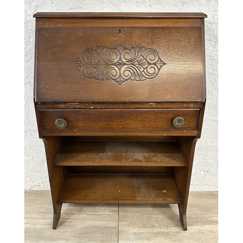 61 - A mid 20th century carved oak student's bureau bookcase - approx. 101cm high x 69cm wide x 32cm deep