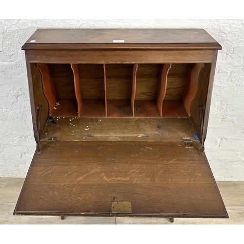 61 - A mid 20th century carved oak student's bureau bookcase - approx. 101cm high x 69cm wide x 32cm deep