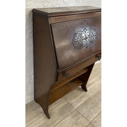 61 - A mid 20th century carved oak student's bureau bookcase - approx. 101cm high x 69cm wide x 32cm deep