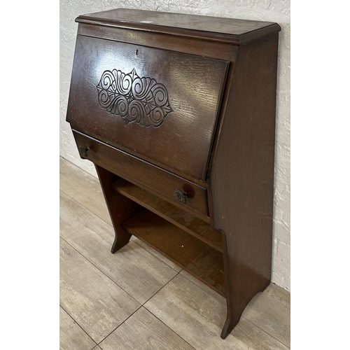 61 - A mid 20th century carved oak student's bureau bookcase - approx. 101cm high x 69cm wide x 32cm deep