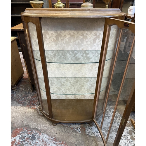 66 - A mid 20th century oak bow fronted display cabinet - approx. 118cm high x 90cm wide x 38cm deep