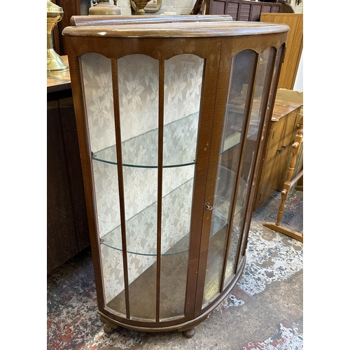 66 - A mid 20th century oak bow fronted display cabinet - approx. 118cm high x 90cm wide x 38cm deep