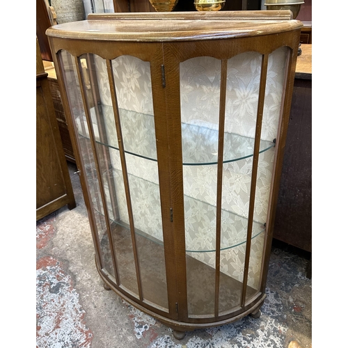 66 - A mid 20th century oak bow fronted display cabinet - approx. 118cm high x 90cm wide x 38cm deep