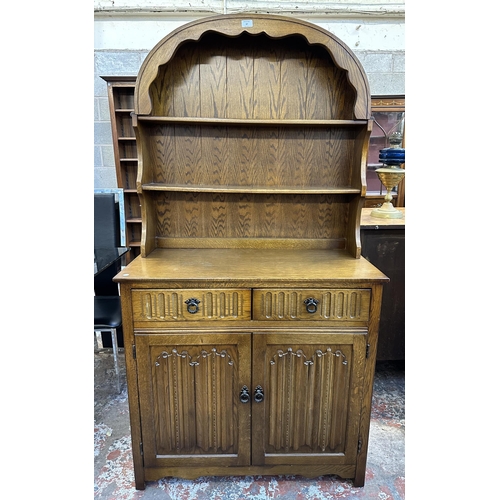 67 - A carved oak linenfold Dutch dresser - approx. 178cm high x 95cm wide x 44cm deep