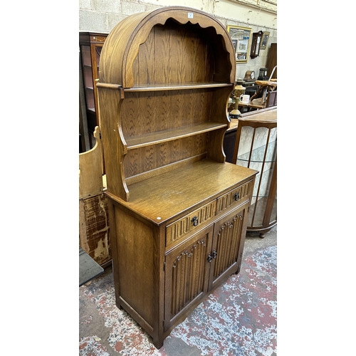 67 - A carved oak linenfold Dutch dresser - approx. 178cm high x 95cm wide x 44cm deep