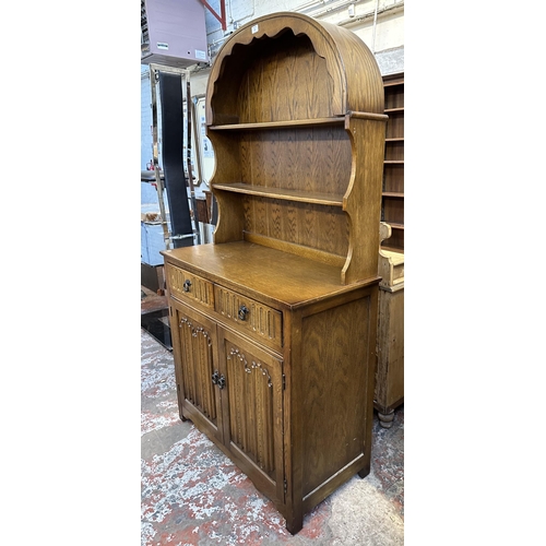 67 - A carved oak linenfold Dutch dresser - approx. 178cm high x 95cm wide x 44cm deep