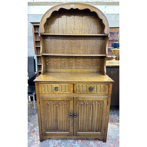 67 - A carved oak linenfold Dutch dresser - approx. 178cm high x 95cm wide x 44cm deep