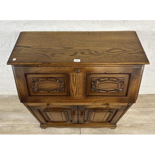 68 - A carved oak bureau - approx. 100cm high x 85cm wide x 43cm deep