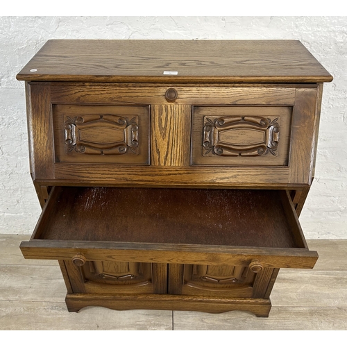 68 - A carved oak bureau - approx. 100cm high x 85cm wide x 43cm deep