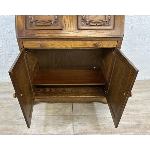 68 - A carved oak bureau - approx. 100cm high x 85cm wide x 43cm deep