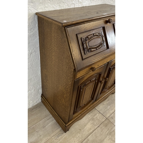 68 - A carved oak bureau - approx. 100cm high x 85cm wide x 43cm deep