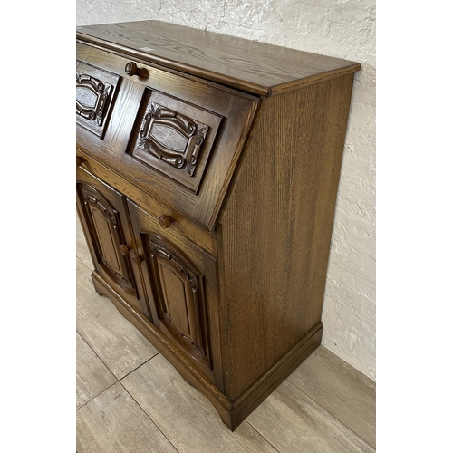 68 - A carved oak bureau - approx. 100cm high x 85cm wide x 43cm deep