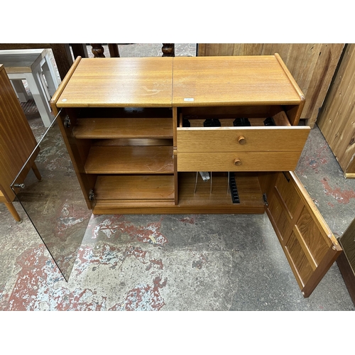 69 - A mid 20th century Nathan teak and smoked glass hi-fi stereo cabinet - approx. 75cm high x 100cm wid... 