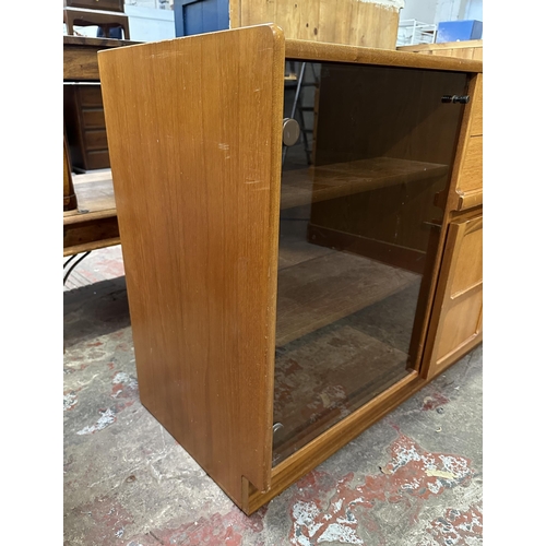 69 - A mid 20th century Nathan teak and smoked glass hi-fi stereo cabinet - approx. 75cm high x 100cm wid... 