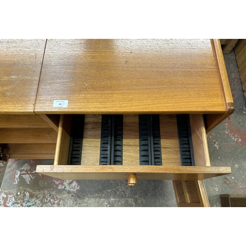 69 - A mid 20th century Nathan teak and smoked glass hi-fi stereo cabinet - approx. 75cm high x 100cm wid... 