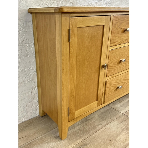 73 - A modern oak sideboard - approx. 81cm high x 114cm wide x 34cm deep