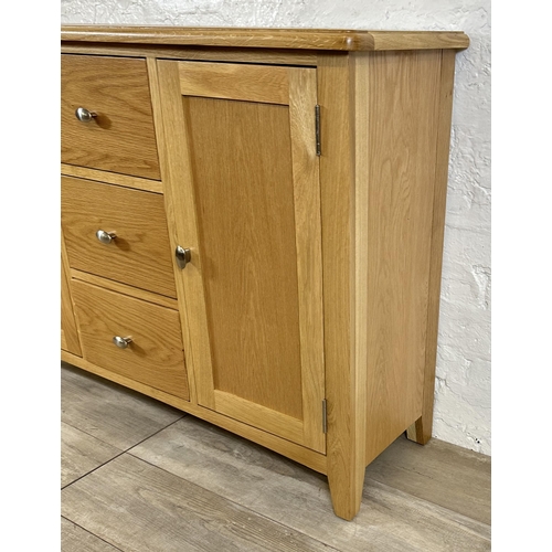 73 - A modern oak sideboard - approx. 81cm high x 114cm wide x 34cm deep