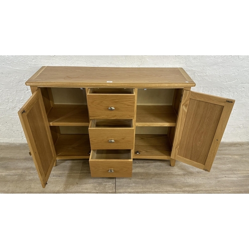 73 - A modern oak sideboard - approx. 81cm high x 114cm wide x 34cm deep