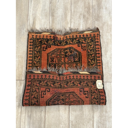 8 - A vintage Afghan orange and black rug - approx. 98cm x 65cm