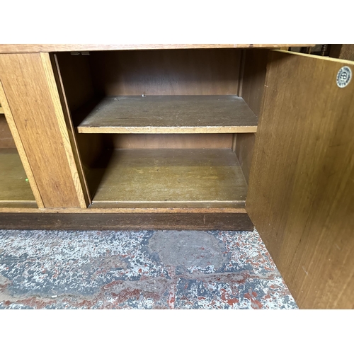 82 - A mid 20th century oak sideboard - approx. 81cm high x 122cm wide x 46cm deep