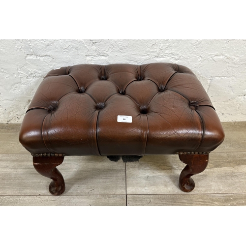 86 - A brown leather Chesterfield footstool on mahogany cabriole supports - approx. 33cm high x 56cm wide... 