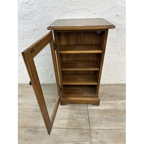 94 - An Ercol Golden Dawn elm CD cabinet - approx. 77cm high x 44cm wide x 38cm deep