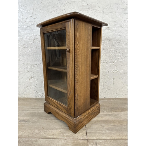 94 - An Ercol Golden Dawn elm CD cabinet - approx. 77cm high x 44cm wide x 38cm deep