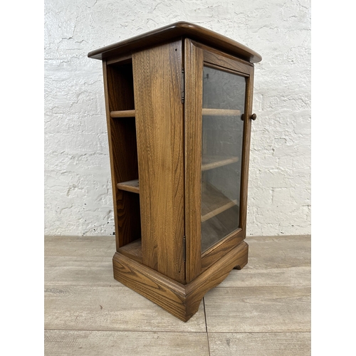 94 - An Ercol Golden Dawn elm CD cabinet - approx. 77cm high x 44cm wide x 38cm deep