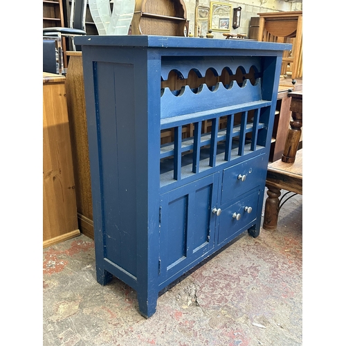 98 - A modern blue painted pine bottle rack cabinet - approx. 104cm high x 97cm wide x 37cm deep