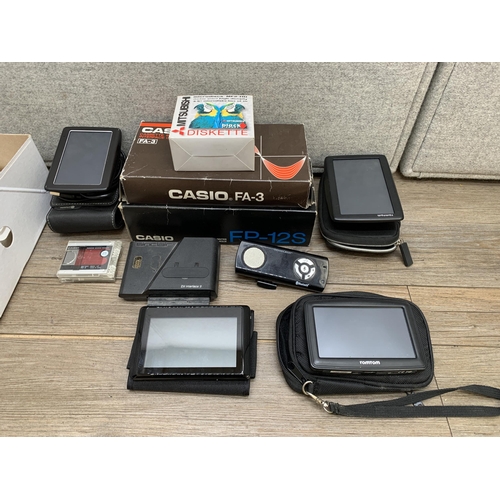 770 - A collection of items to include TomTom 4EN52 satnav, Mitsubishi MF2-HD microdiscs, Casio FP-12S min... 