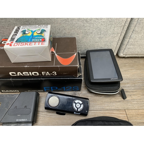 770 - A collection of items to include TomTom 4EN52 satnav, Mitsubishi MF2-HD microdiscs, Casio FP-12S min... 