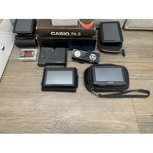 770 - A collection of items to include TomTom 4EN52 satnav, Mitsubishi MF2-HD microdiscs, Casio FP-12S min... 