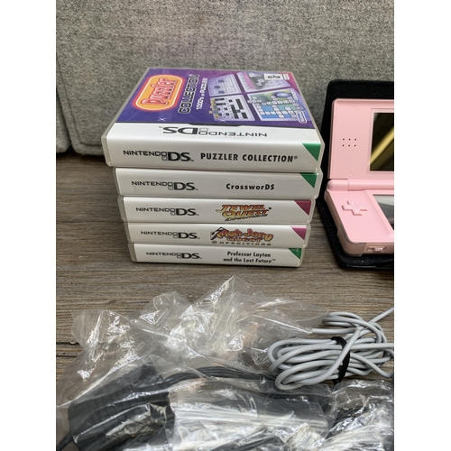 772 - Two cased Nintendo handheld game consoles, one DS XL with charger and one DS Lite with accessories a... 