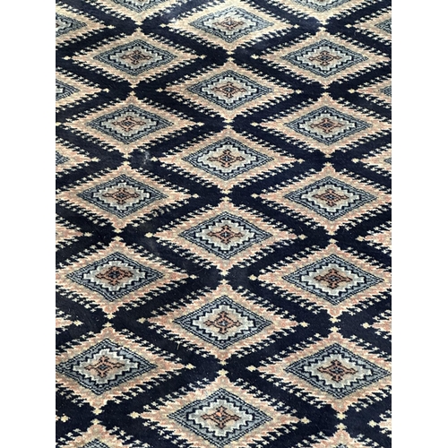 12 - A G. H. Frith Ltd Pakistan handmade dark blue 100% wool pile rug - approx. 248cm x 157cm