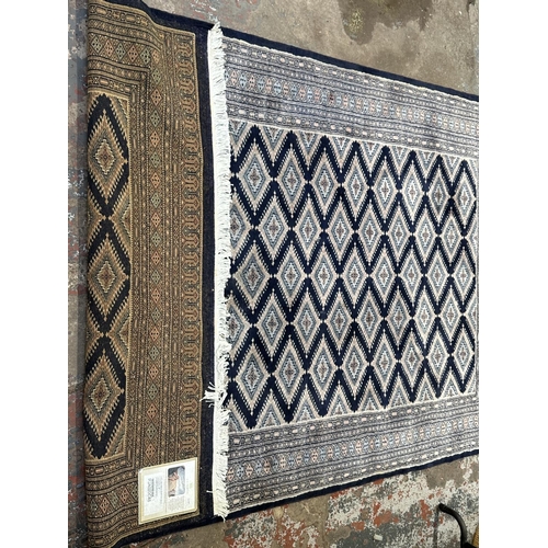 12 - A G. H. Frith Ltd Pakistan handmade dark blue 100% wool pile rug - approx. 248cm x 157cm