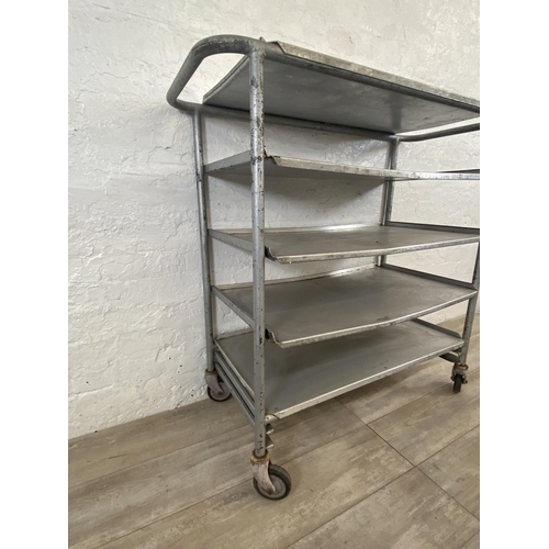 215 - A mid 20th century steel and aluminium five tier catering trolley - approx. 105cm high x 45cm wide x... 