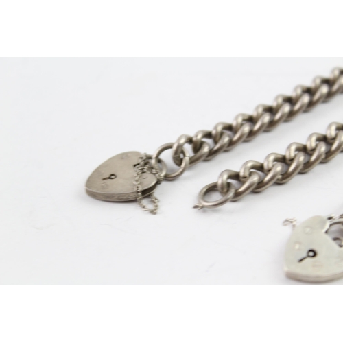 2033 - Two sterling silver gate bracelets with heart padlock clasps - approx. gross weight 53g